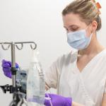 A nursing student check a device in the lab