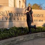 Noel Pacheco, a woman standing at right near a Case Western Reserve university sign