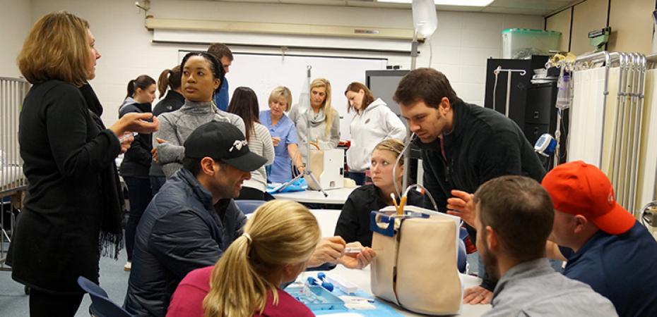 Students learn from a professor in an epidural clinical lab at the Frances Payne Bolton School of Nursing at Case Western Reserve University in Cleveland, Ohio.