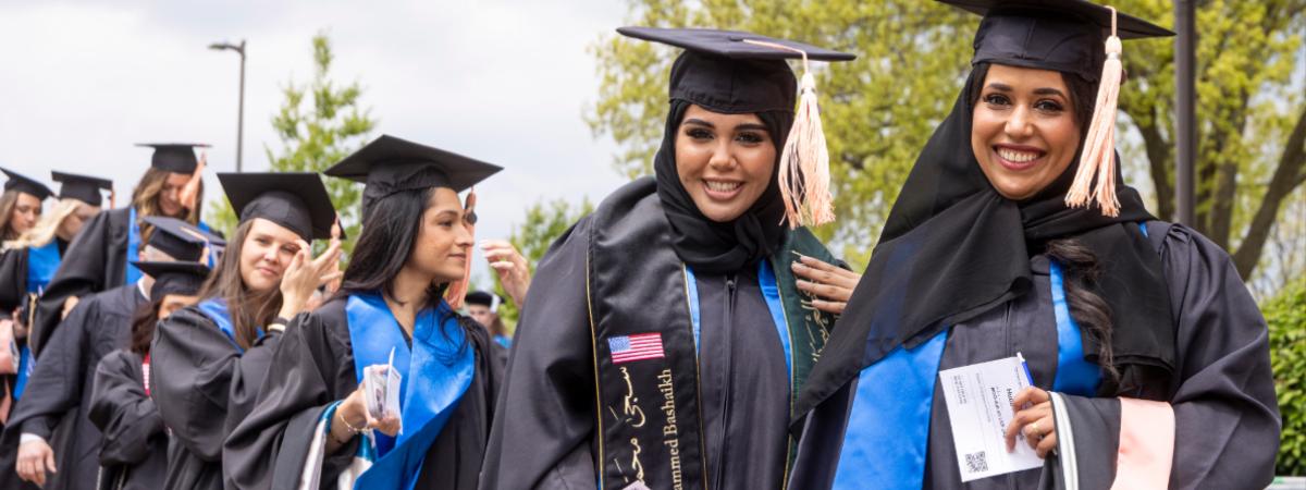 Nursing students in commencement regalia line up to enter the ceremony.