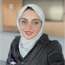 Rayhanah R Almutairi smiling wearing headscarf