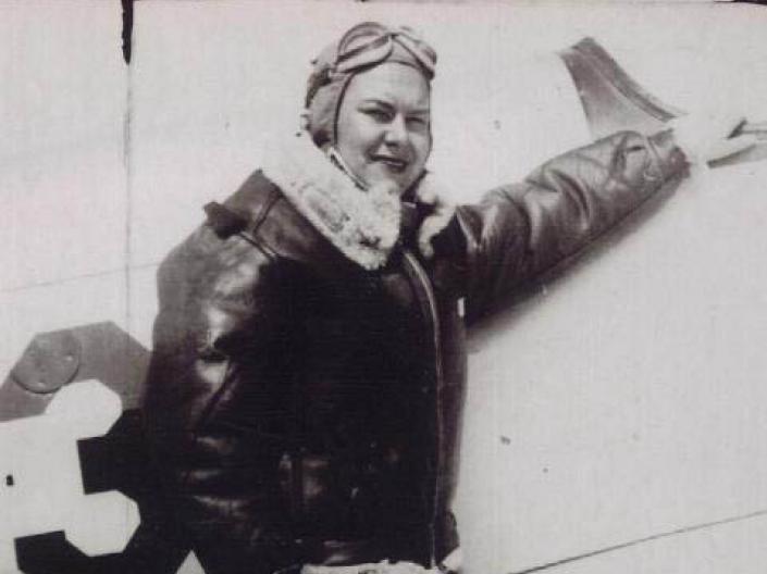 Picture of Dorothy Ebersbach standing next to a airplane.