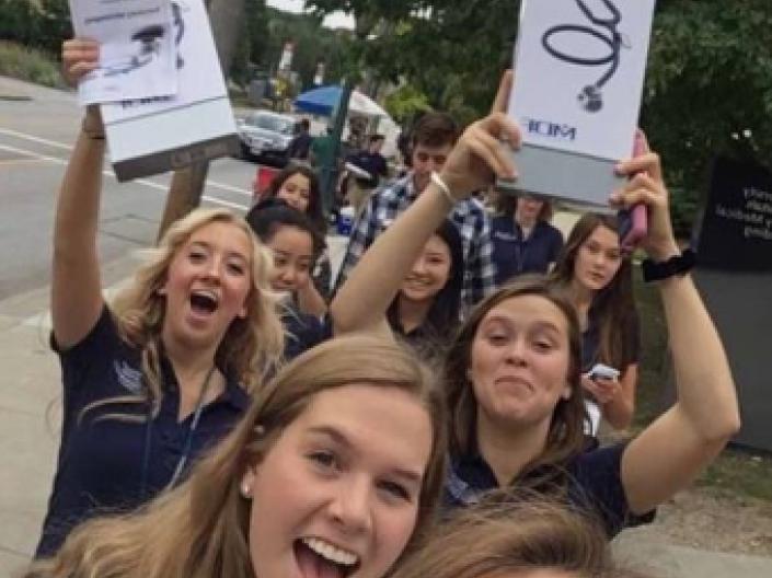 picture of students showing off their new stethoscopes.