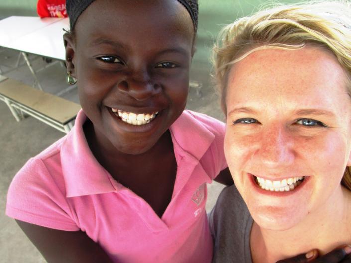 Diana hugging a student in Haiti at a local orphanage.