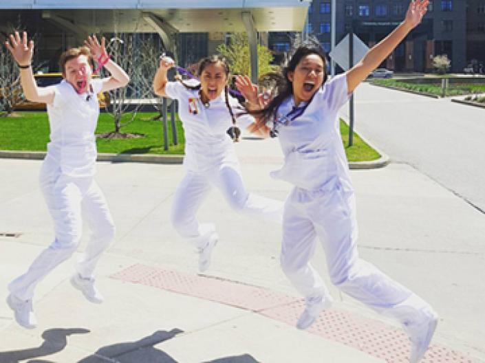 Karyn Rapundalo and classmates jumping for joy in front of University Hospitals Cleveland Medical Center.