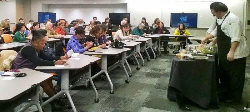 A Bon Appetit chef leads a cooking demonstration in front of a class at Case Western Reserve University