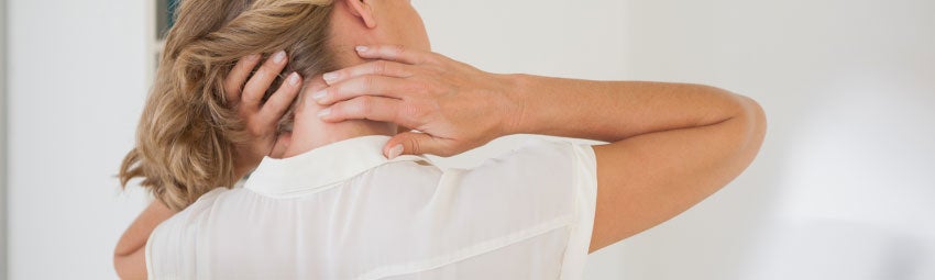 stock image of a woman holding her neck