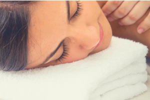 Woman with head on towel getting a massage