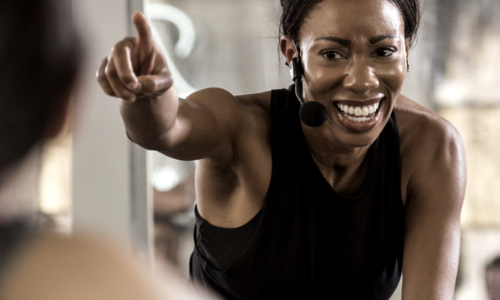 woman cycle instructor pointing and smiling