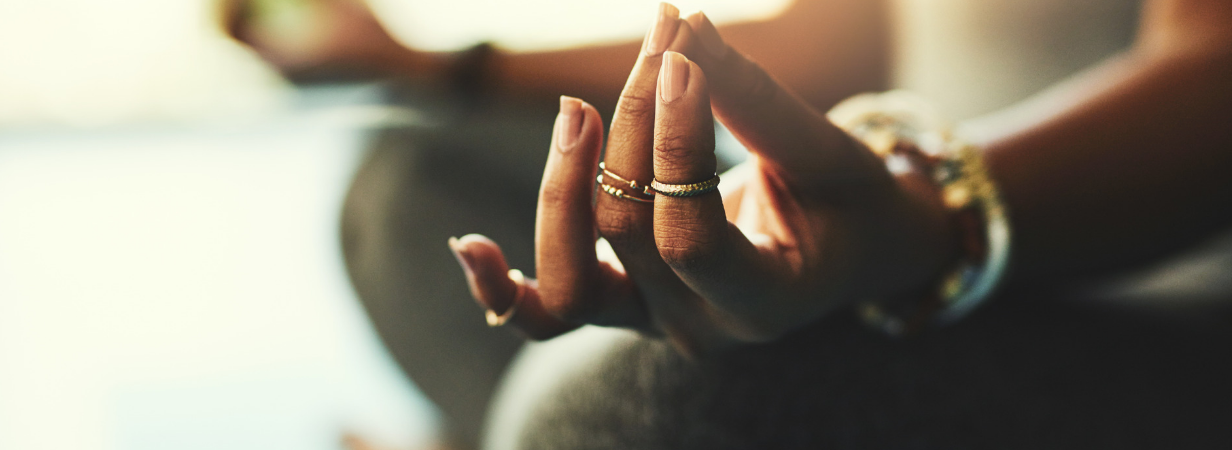 closeup of woman's hands in om meditation