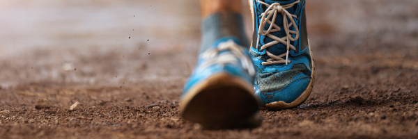 Blue shoes walking or running in dirt