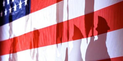 American Flag with shadows of soldiers