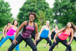 Women doing Zumba in grass