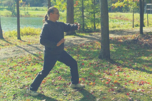 Man doing yoga outside on grass