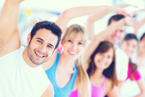 five people stretching during group exercise class