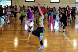 large group doing Zumba in gymnasium