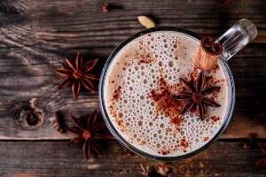 chai tea smoothie with star anise in glass mug
