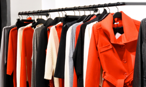 red and black clothing hanging from rack