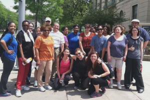 Group of people posing for camera outside