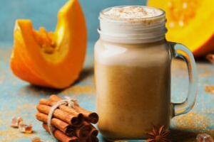 Shake in mason jar with pumpkin and cinnamon around it