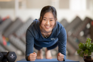 Woman doing plank looking at camera