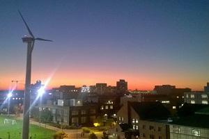 Windmill with sunset and campus in background
