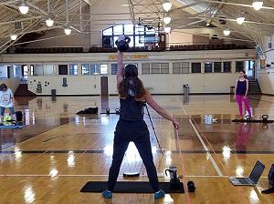 Woman holding kettlebell in a gym