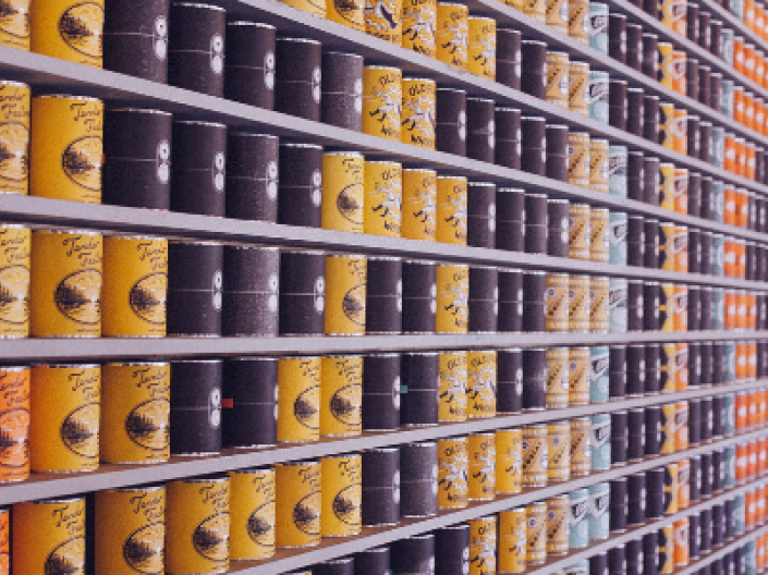 canned food in aisle on shelves