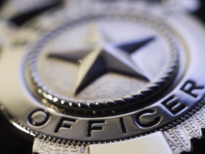 close up of police officer badge silver