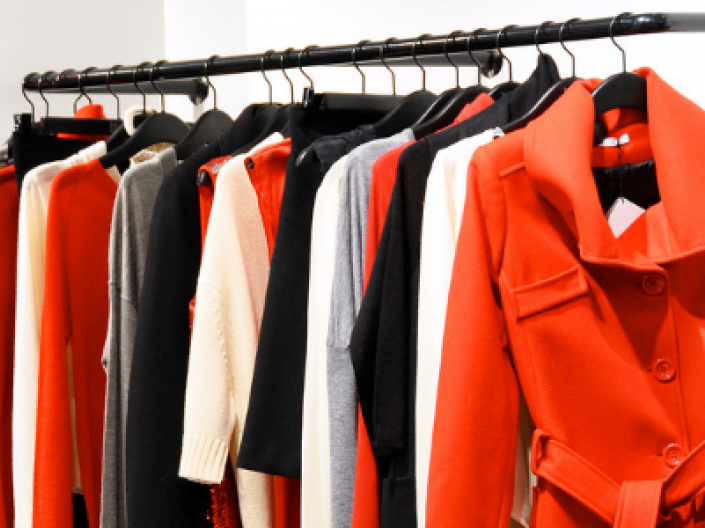 red and black clothing hanging from rack
