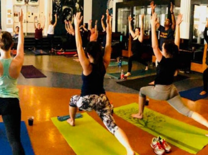 Yoga class in pose reaching to the ceiling