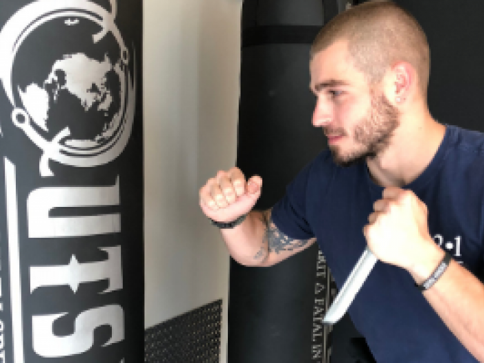 May in front of heavy bag with demo knife