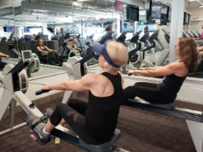 two women on rowing machines