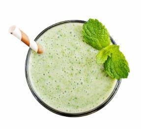 Green shake from the top with straw and mint leaves