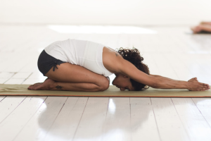 Woman in yin yoga pose on yoga mat