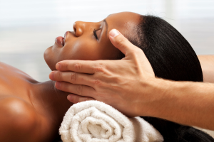 Woman with head on towel and hands on each side of face