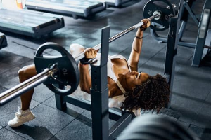 Woman performing a bench press with a barbell