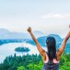 Happy woman at top of mountain trees and lake below Case Western Reserve University Weight Loss MOOC