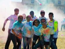 Case Western Reserve University students celebrating Holi shirts covered in colored powder