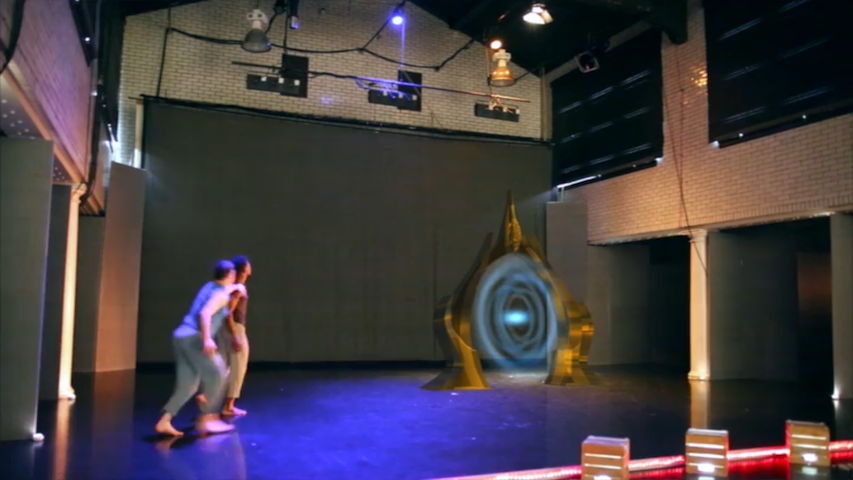 dancers performing on stage with holographic effects.