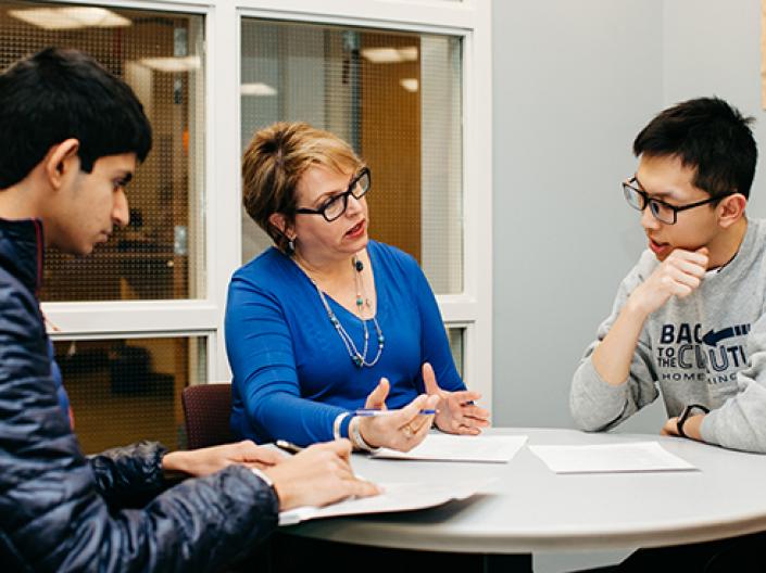 A staff member meeting with students to talk about their careers