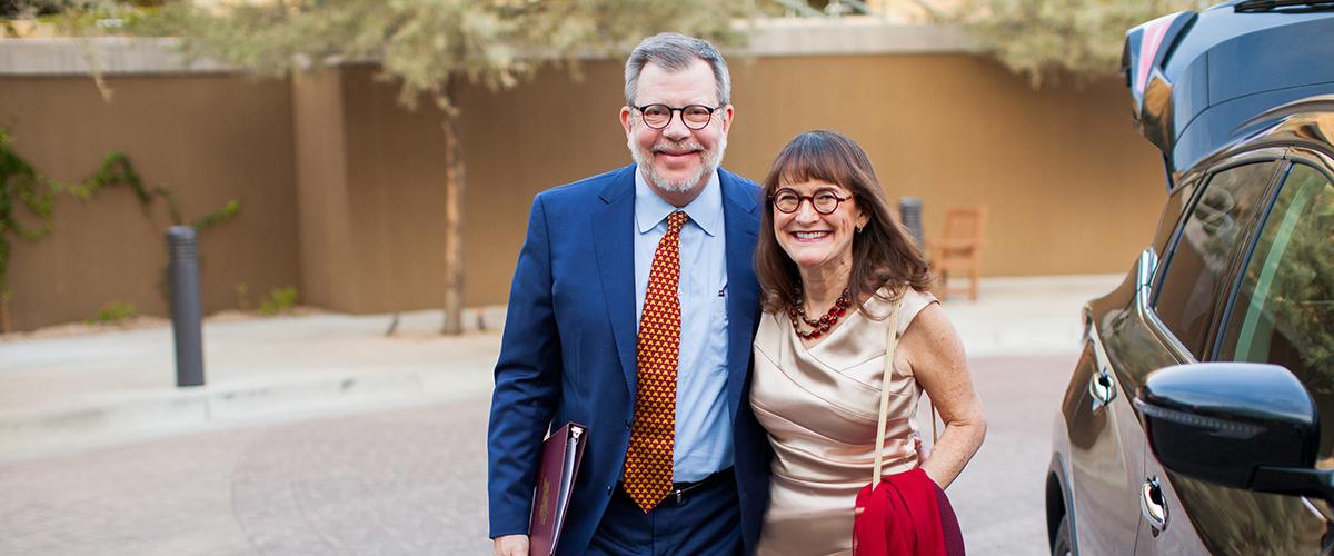 Case Western Reserve University President Eric Kaler and his wife Karen walking arm-in-arm.