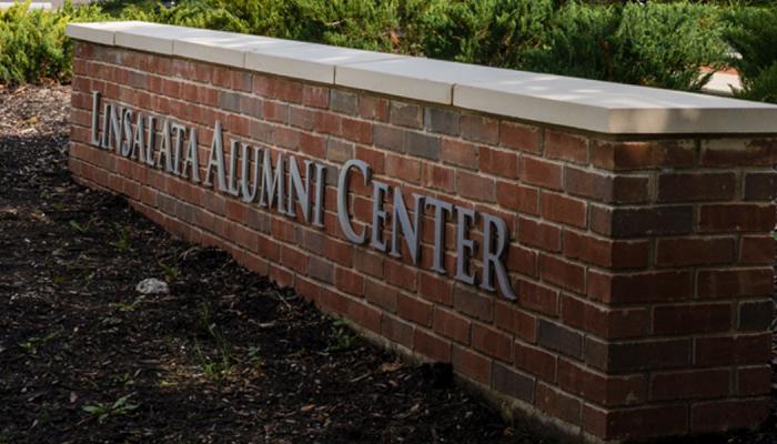 Brick wall with lettering that says Linsalata Alumni Center