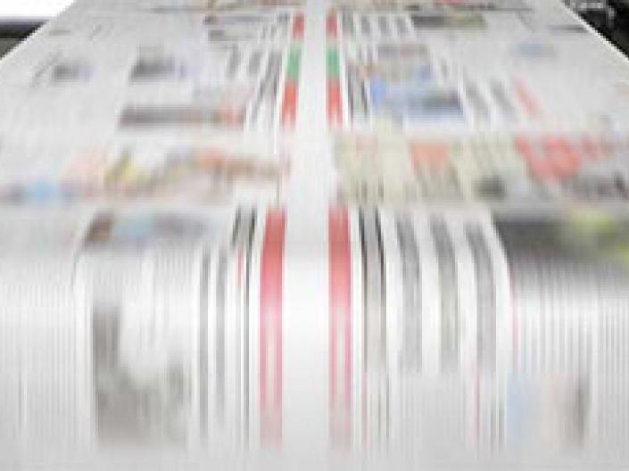 Paper rolling through a printing press