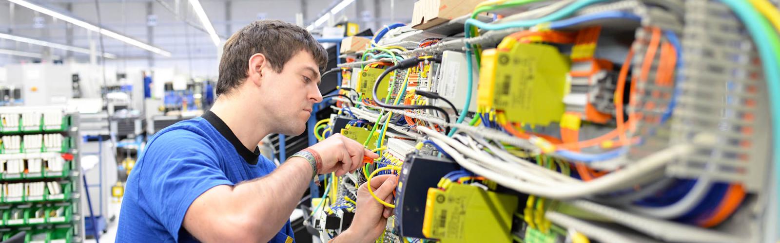 An electrical student working on hardware