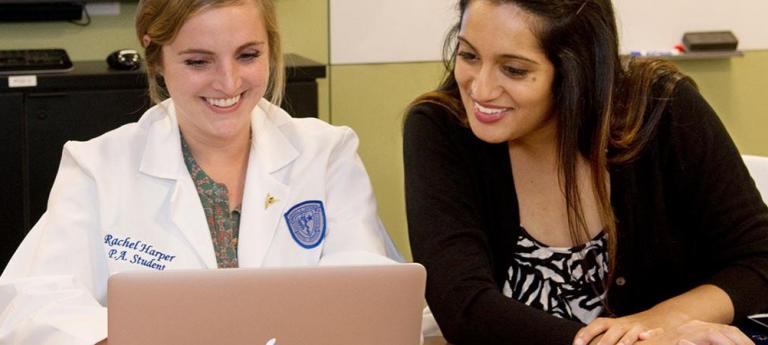 Physician Assistant Studies students working at a computer during class