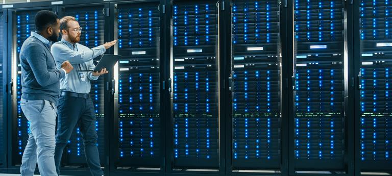 Two students walking through a data center
