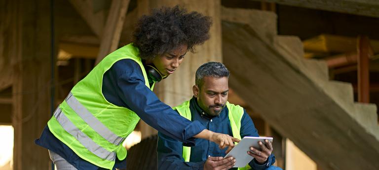 Two Civil Engineers working on site