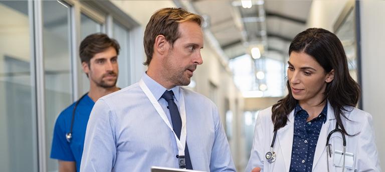 EMBA student talking with a doctor 