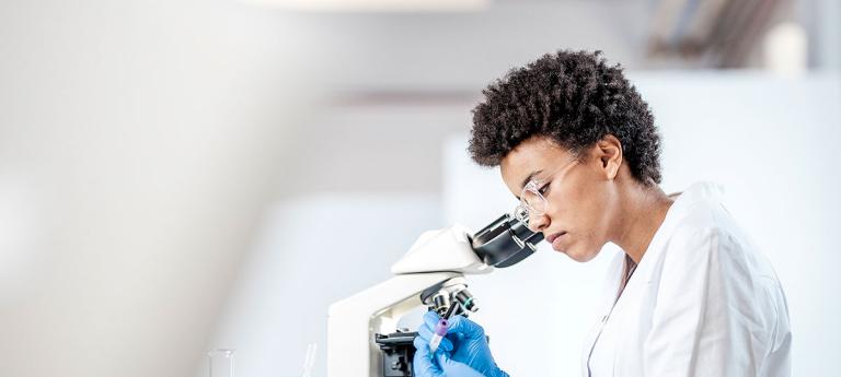 CTS student using a microscope to view a slide